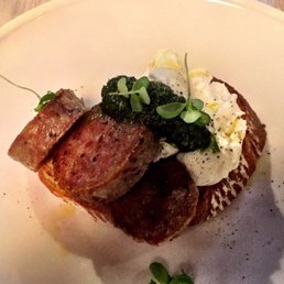 Salsicce breakfast -- poached eggs with salsa verde on sourdough and ridiculously generous portion of cotechino sausage.