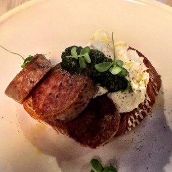 Cecconi's Flinders Lane - Salsicce breakfast -- poached eggs with salsa verde on sourdough and ridiculously generous portion of cotechino sausage. - Restaurants Near Me - Melbourne, VIC