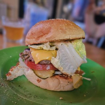 Ma Mère En Feu - a burger on a green plate - Desserts Near Me - Montreal, Quebec