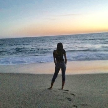 Full Moon Drum Circle - a woman walking on the beach - Music Venues Near Me - Laguna Beach, California