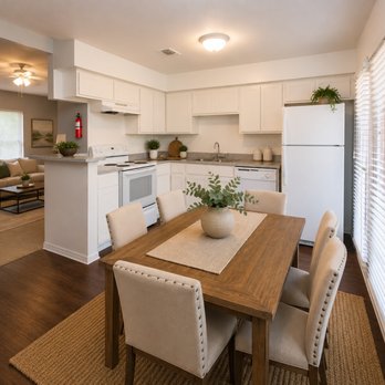 Brittany Square Apartments - Clean, open-concept kitchen and dining area with classic white cabinets, full-size refrigerator, and charming natural light. - Apartments Near Me - Rosenberg, Texas Brittany Square Apartments - Clean, open-concept kitchen and dining area with classic white cabinets, full-size refrigerator, and charming natural light. - Apartments Near Me - Rosenberg, Texas