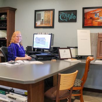 Souris River Designs - a woman sitting at a desk - General Contractors Near Me - Minot, North Dakota