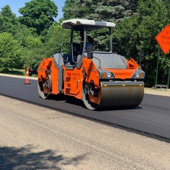Hutch Paving - a road being paved with asphalt - General Contractors Near Me - Warren, Michigan