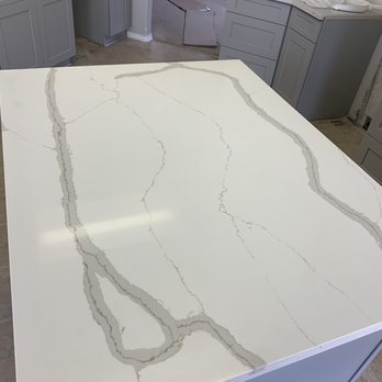 Linda Cabinets & Granite - Quartz countertops in Gold Calcutta design. Loved this piece. We had our island extended so that you can actually sit under it and eat. - Cabinetry Near Me - Austin, Texas