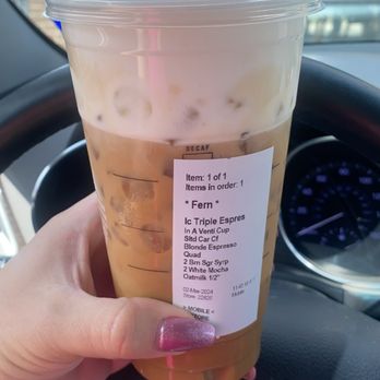 Starbucks - a hand holding a cup of iced coffee - Coffee & Tea Near Me - Uvalde, Texas