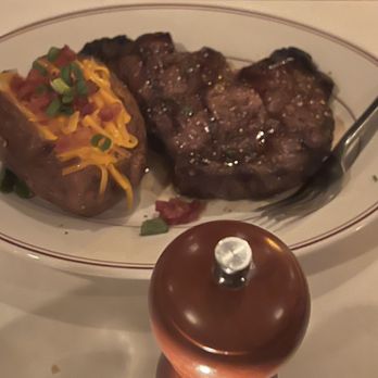 Char Restaurant - Ribeye cooked medium well (although we asked for medium) but it was all good paired with a loaded baked potato - Steakhouses Near Me - Jackson, Mississippi