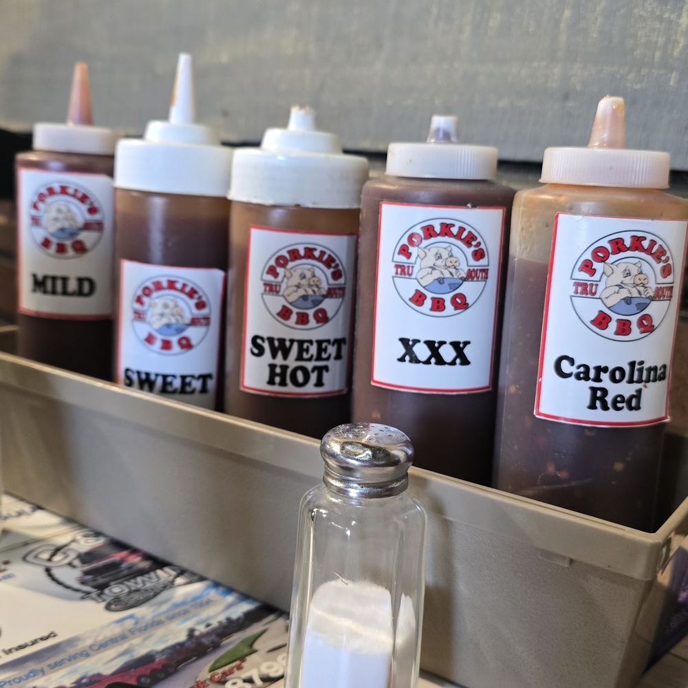 Porkies BBQ - 5 of the 7 sauces, these are on all tables the others are OMG (ghost pepper) and Afterburner and these two are on the counter - Barbeque Near Me - DeLand, Florida Porkies BBQ - 5 of the 7 sauces, these are on all tables the others are OMG (ghost pepper) and Afterburner and these two are on the counter - Barbeque Near Me - DeLand, Florida
