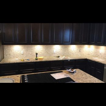 Goliath Building Services - a kitchen with black cabinets - General Contractors Near Me Goliath Building Services - a kitchen with black cabinets - General Contractors Near Me