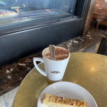 Caffe Nero - Cappuccino and Almond Biscotti by the fireplace - Cafes Near Me - Darien, Connecticut