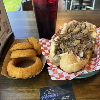 Philly Flats - Philly cheesesteak sandwich with onions, provolone cheese, and hot peppers. And freshly made onion rings. - Chicken Wings Near Me - Katy, Texas
