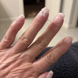 French manicure with a white flower. So beautiful.
