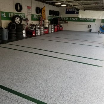 Epoxy Surfaces - a garage with a lot of tires - Flooring Near Me Epoxy Surfaces - a garage with a lot of tires - Flooring Near Me