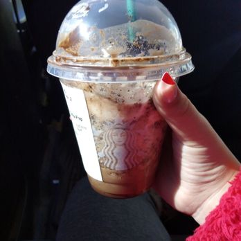 Starbucks - a hand holding a cup of iced coffee - Coffee & Tea Near Me - Marshall, Texas