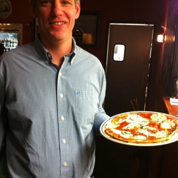 Brick Oven Bistro - John, one of the owners serving up a delicious pizza. - Pizza Near Me - Buffalo, New York Brick Oven Bistro - John, one of the owners serving up a delicious pizza. - Pizza Near Me - Buffalo, New York