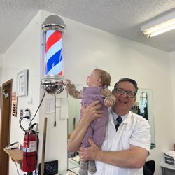 Mike & Jim's Barber Shop - Barber Jim and granddaughter Logan.
