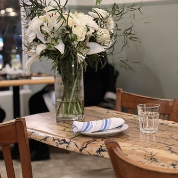 Rudolfo's - Live Edge Table with Fresh Flowers at the center of the restaurant - Italian Near Me - Pacific Grove, California Rudolfo's - Live Edge Table with Fresh Flowers at the center of the restaurant - Italian Near Me - Pacific Grove, California