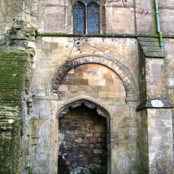 Malmesbury Abbey - A blocked Decorated Gothic doorway within the frame of an earlier Romanesque door. - Churches Near Me - Malmesbury, WIL