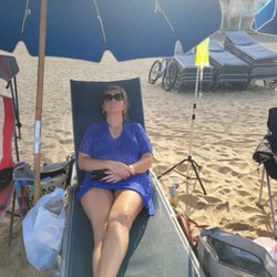 Client receiving IV hydration on the beach.