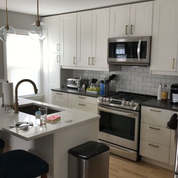 V5 Remodelers - a kitchen with white cabinets and stainless steel appliances - General Contractors Near Me V5 Remodelers - a kitchen with white cabinets and stainless steel appliances - General Contractors Near Me
