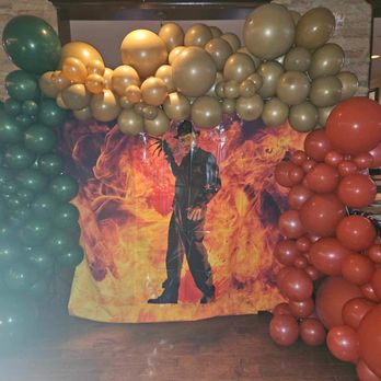 PT's Gold - a man standing in front of a backdrop of balloons - Sports Bars Near Me - Las Vegas, Nevada PT's Gold - a man standing in front of a backdrop of balloons - Sports Bars Near Me - Las Vegas, Nevada