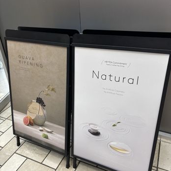 HeyTea - Two black A-frame signs outside HeyTea in Tysons, VA, advertise tea offerings with minimalist designs and text. - Bubble Tea Near Me - Tysons, Virginia