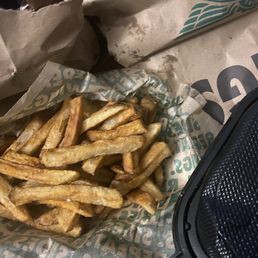 Fries were spilled all over the oversized bag. Fries were spilled all over the oversized bag.