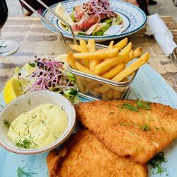 Café Valentin - Foreground: Panerede Fiskefilet, your basic lightly breaded whitefish, salad, and fries with remoulade. Background: Parma Ham Salad.