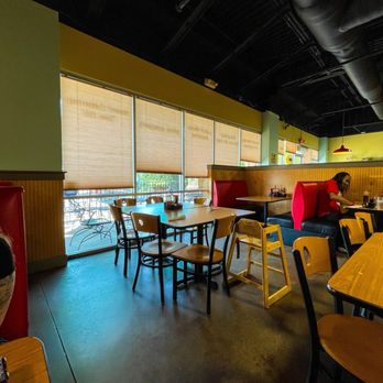 Eggs Up Grill - a man sitting at a table - Waffles Near Me - Irmo, South Carolina