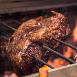 Rei Do Gado Brazilian Steakhouse - Slow Cooked Beef Ribs over Mesquite Charcoal Grill