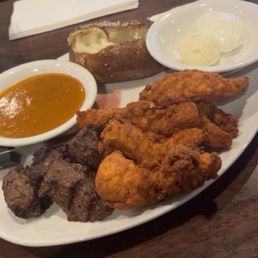 Sirloin Tips & Chicken Tenders with baked potato and golf fever sauce. Yum!