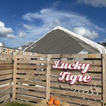 Lucky Tigre - Front of food truck and table area - Food Trucks Near Me - Tampa, Florida Lucky Tigre - Front of food truck and table area - Food Trucks Near Me - Tampa, Florida