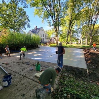 JT & Sons Lawn Care - workers working on a concrete slab - Lawn Services Near Me