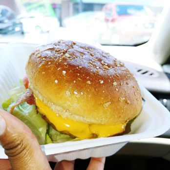 Clean Eatz - a hand holding a hamburger with cheese and lettuce - Salad Near Me - Norfolk, Virginia