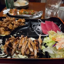 Bento box.  Sashimi, terriyaki chicken, sesame chicken