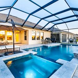 Artesian Pools Of Orlando - A compact pool-spa combo with modern lines, perfect for relaxing and entertaining under the screen enclosure.