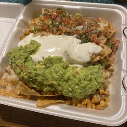 Grilled chicken nachos with melted mozzarella , pico de Gallo fresh guacamole and  sour cream . And for $6.30 come on !! It's perfect .