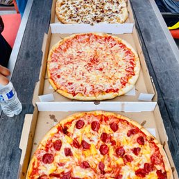 a row of pizzas