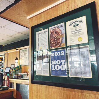 Marion's Piazza - a man sitting at a table in a restaurant - Pizza Near Me - Dayton, Ohio