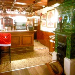 A wonderful old Austrian green tile stove dominates the bar area