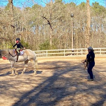 New Beginnings Farm - Instructor Meredith Philipps teaching a lunge lesson to a regular student on lesson horse Paco. - Horseback Riding Near Me - Pittsboro, North Carolina New Beginnings Farm - Instructor Meredith Philipps teaching a lunge lesson to a regular student on lesson horse Paco. - Horseback Riding Near Me - Pittsboro, North Carolina