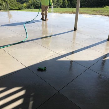 Summit Concrete And Construction - a person washing a patio - Masonry/Concrete Near Me