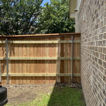 JR Scapes And Land Services - a back yard with a fence - Tree Services Near Me - Austin, Texas