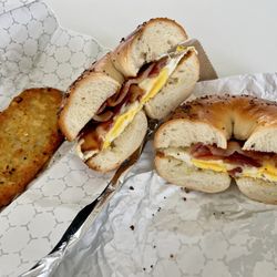 Lighthouse Bagels & Deli - Bacon Egg Cheese on a toasted ET bagel with a hash brown side order. Had to crisp up the hb at home. Delicious, big & hearty sando.