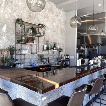 Costa Contemporary Kitchen - a bar with chairs - Peruvian Near Me - Costa Mesa, California Costa Contemporary Kitchen - a bar with chairs - Peruvian Near Me - Costa Mesa, California