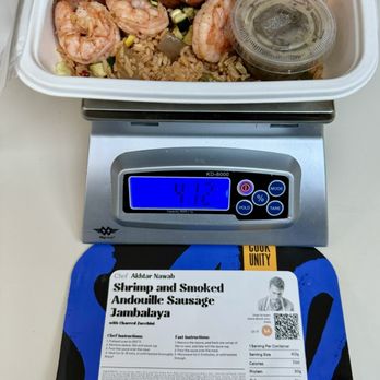 Cook Unity - a scale with shrimp and sausage on it - Food Delivery Services Near Me