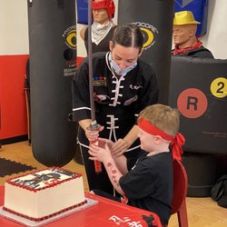 Master Gohring's Tai Chi & Kung Fu - Cutting his cake with a samurai sword! He was so, so excited.