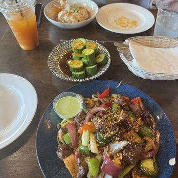 OMELI Kitchen - cucumber salad, spicy wontons, shaken beef garlic noodles, tra le chi (lychee peach iced tea) - Vietnamese Near Me - Fullerton, California