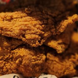 Cajun Bay Seafood & Bar - 4 Fish  fillets , fries and hushpuppies are underneath the fillets