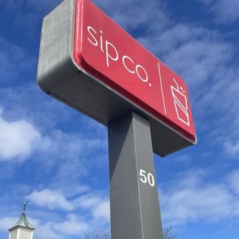 Sip Co - a red and white sign with a steeple in the background - Juice Bars & Smoothies Near Me - Concord, North Carolina Sip Co - a red and white sign with a steeple in the background - Juice Bars & Smoothies Near Me - Concord, North Carolina