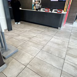 There is water starting to emerge from under the counter.